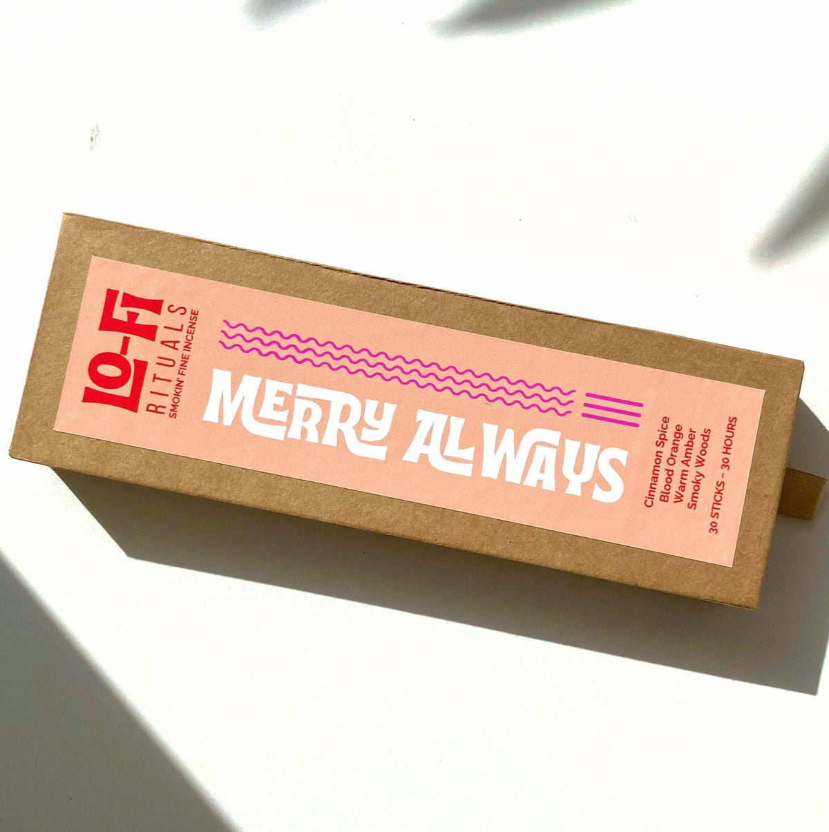 Lo-Fi Rituals Merry Always incense with a bright, bold and modern red, peach and pink label on a bright white background