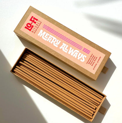 An open box of Lo-Fi Rituals Almost Merry Incense, the golden brown oak wood incense stick are visible