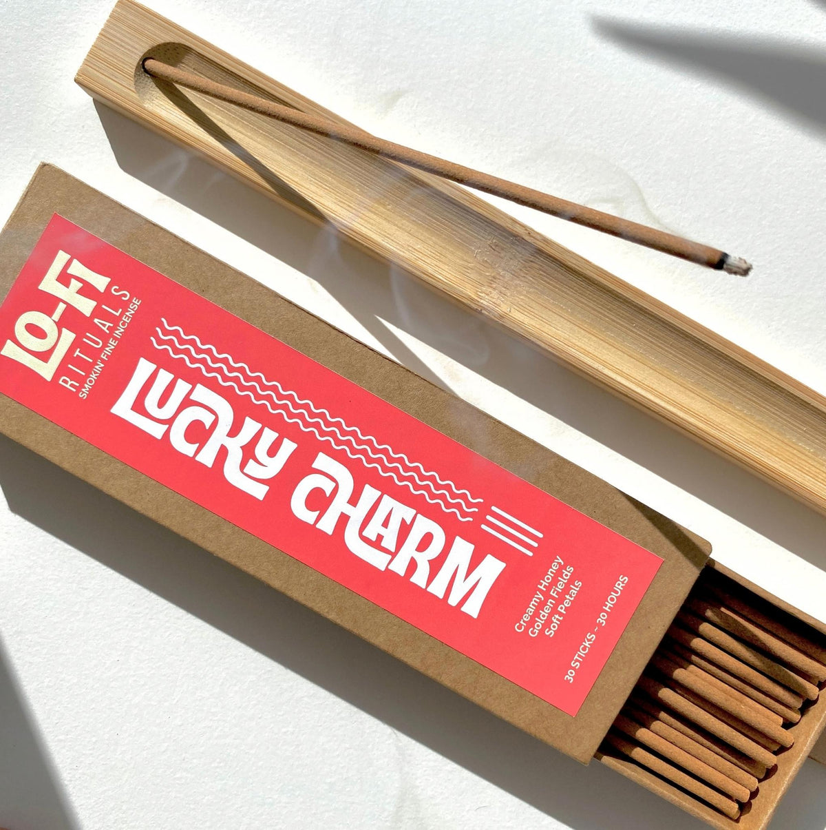 Lo-Fi Rituals classic kraft box with bright, bold modern label stating 'Lucky Charm' creamy honey, floral incense
