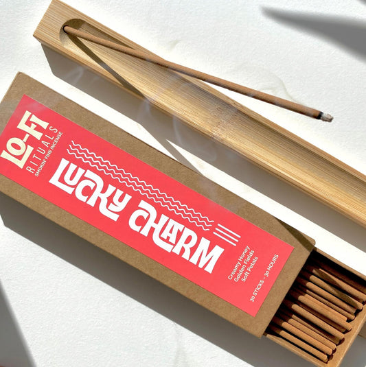 Lo-Fi Rituals classic kraft box with bright, bold modern label stating 'Lucky Charm' creamy honey, floral incense
