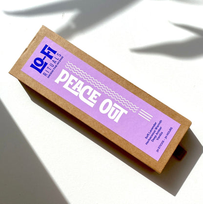 Lo-Fi Rituals Peace Out incense with a bold, modern label with scent notes for lavender, herbs, amber and vanilla. Photographed on a sunlit white background with deep shadows.