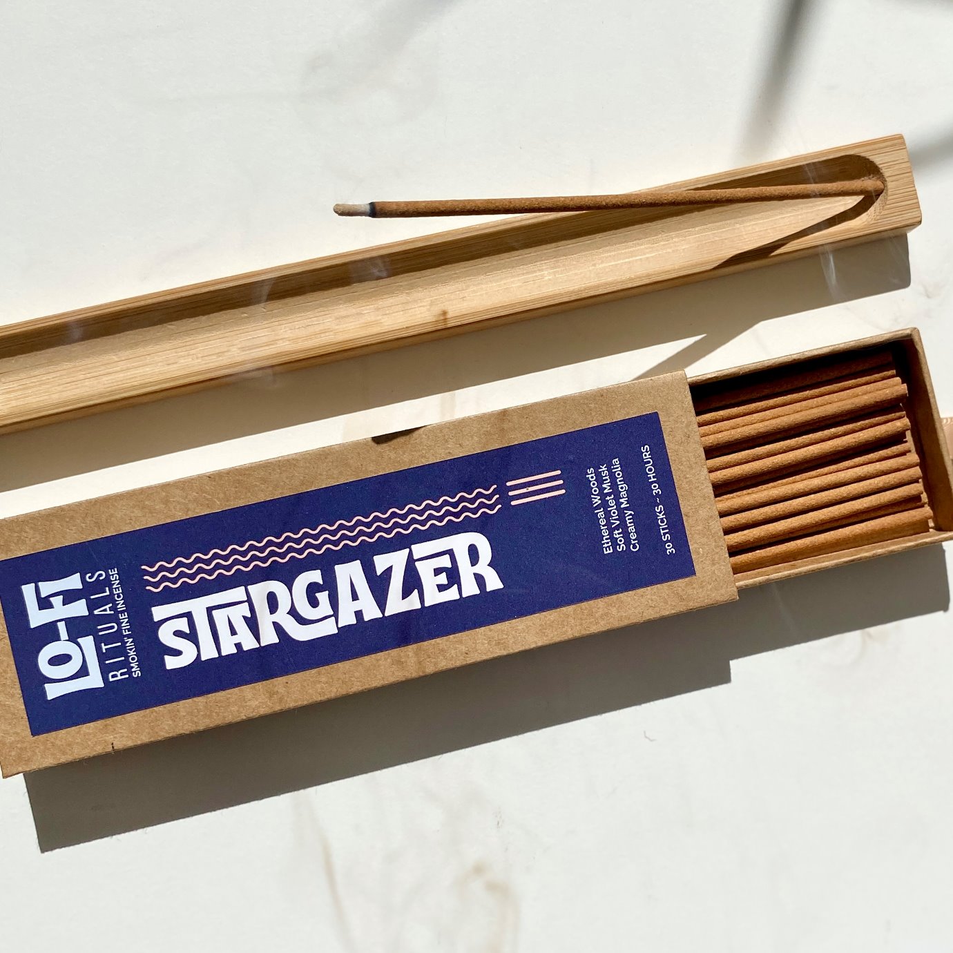 Open box of Lo-Fi Rituals Stargazer incense sticks with a bold modern label on a light background