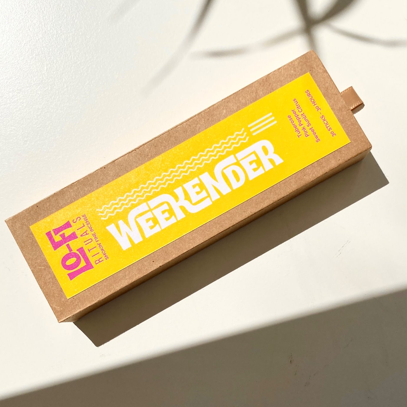 Bright morning sun lights up a box of Lo-Fi Rituals Weekender incense, casting cinematic shadows