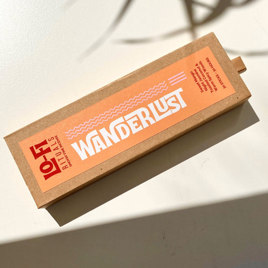 Boldly labelled Lo-Fi Rituals Wanderlust incense box on a sunlit white background, casting cinematic shadows
